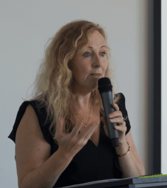 Lyn Baird speaking to an audience.