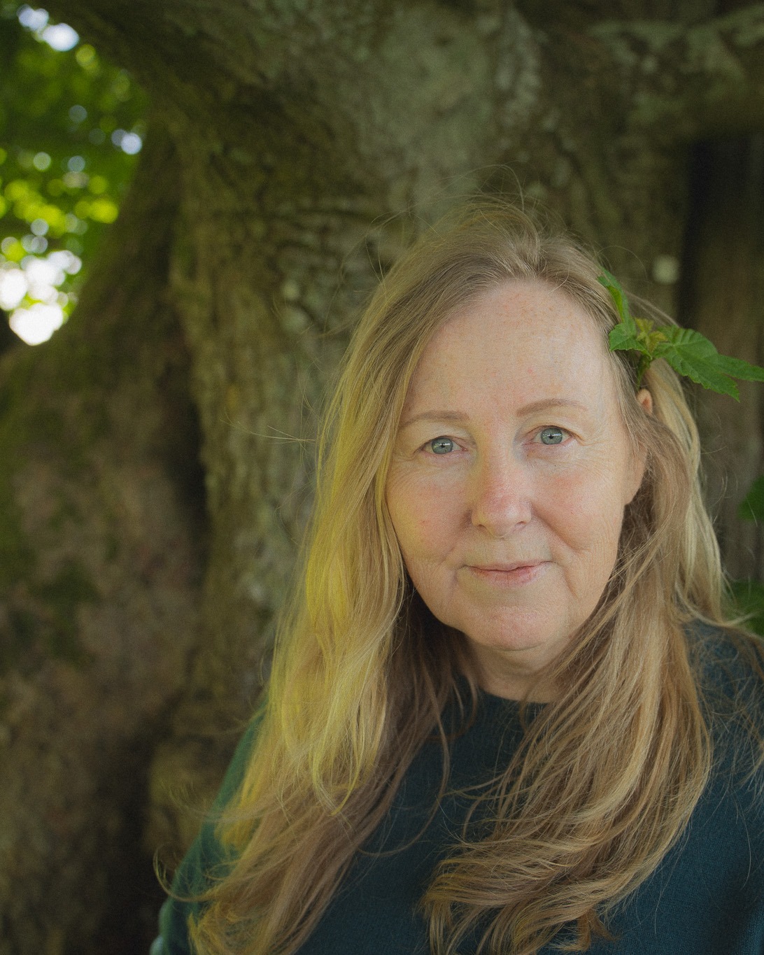 Lyn Baird standing beneath a mature tree
